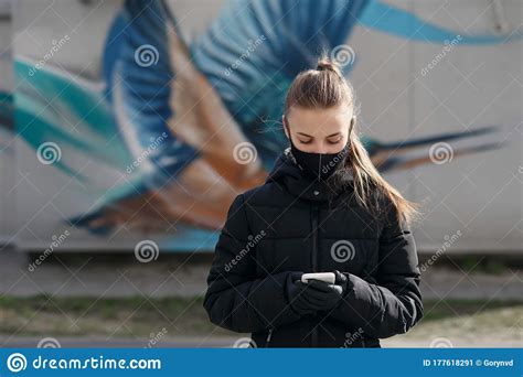 Young Girl In City Street Wearing Black Sterile Medical Face Mask