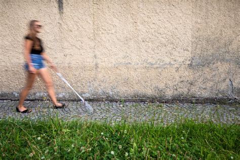 Blind Woman Walking On City Streets Using Her White Cane Stock Image