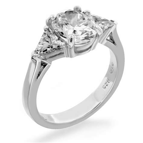 Get inspired by our collection of complete engagement rings. Three stone ring trilliant side stones oval center | Fine ...