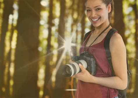 Young Happy Photographer In The Forest With Flares And Bokeh Overlap