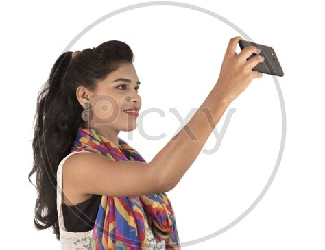 Image Of A Happy Young Indian Girl Taking Selfie With Smart Phone