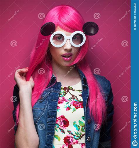 Young Fashionable Woman With Pink Hair And Big Sunglasses Over Pink