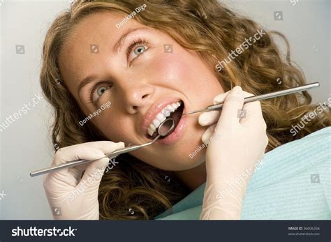Awesome Woman With Open Mouth During Oral Checkup At The Dentists Stock