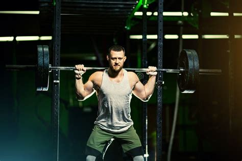 Man With Heavyweight Barbell In The Dark Gym Stock Image Image Of