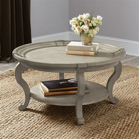 <br /> <br />the sturdy, warm feel of the solid pine top and shelf below are further accented by the wonderful butternut finish. Carrington Coffee Table | Ballard Designs