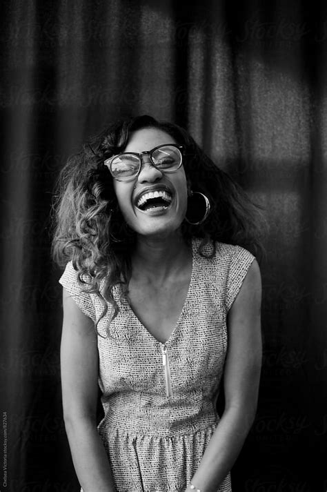 Black And White Portrait Of A Young Woman Laughing By Stocksy