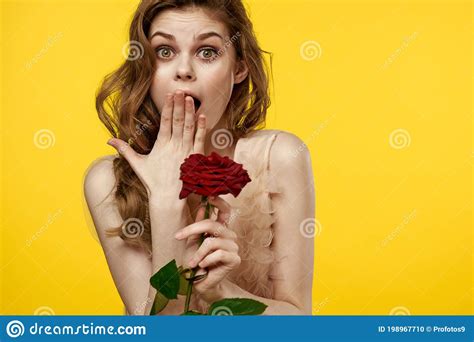 Romantic Woman In Evening Dress With Red Rose On Yellow Background Cropped View Portrait Stock