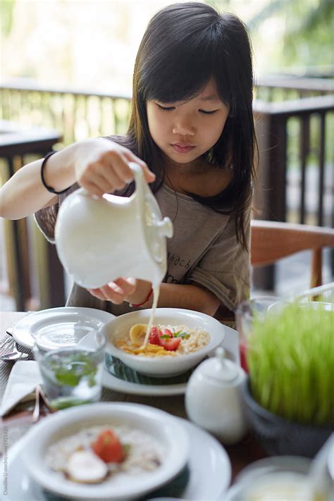 Cute Asian Girl Is Eating Rich Healthy Breakfast In By Stocksy Contributor Chaoshu Li Stocksy