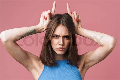 Image Of Angry Brunette Woman Holding Fingers On Her Head Like Devil