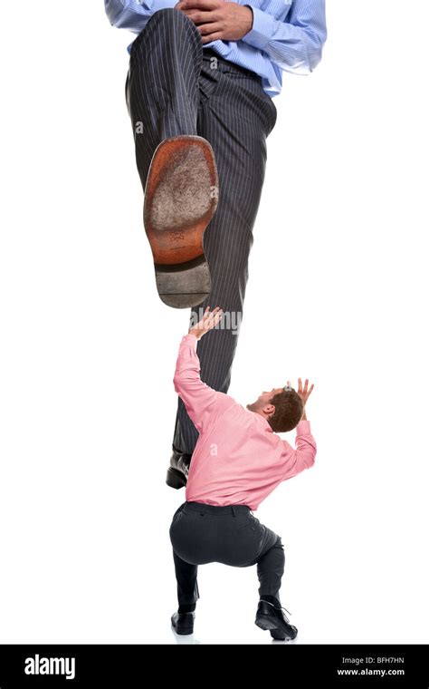 A Businessman About To Be Stepped On By A Giant Foot Isolated On A