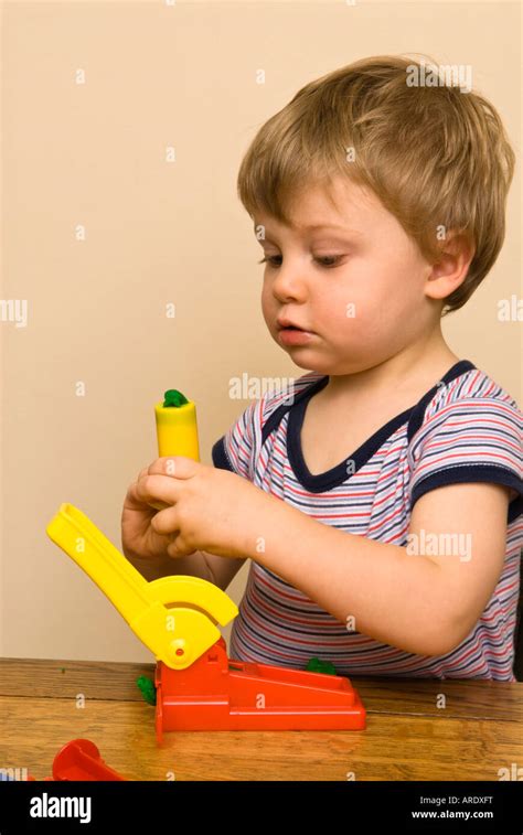 Boy Toddler Child Playing With Play Dough Tools And Toys Cutting And