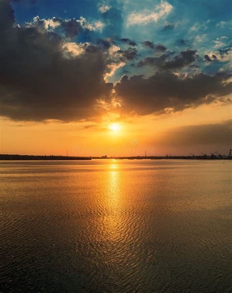 Orange Sunset In Dramatic Clouds Over Water Stock Image Image Of