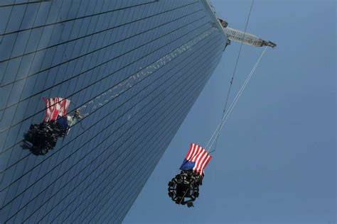 Flag Covered Spire Hoisted To Wtc Roof