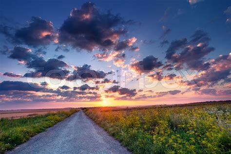 Colorful Summer Sunrise In The Countryside With Road Stock Photo