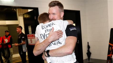 The 'virgin' mother and child. Nathan Buckley hugged by son Jett after Collingwood beat ...