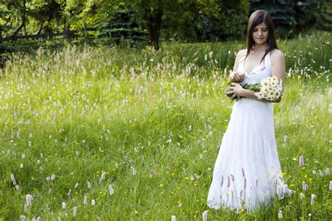 Beautiful Girl Picking Flowers In A Meadow Royalty Free Stock Photos