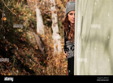 Woman Hiding Behind Wall In Forest Stock Photo Alamy