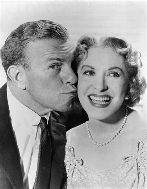 an old black and white photo of a man kissing a woman s forehead with her eyes closed