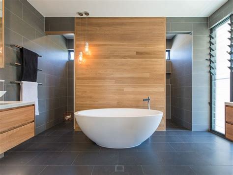 To add contrast, switch up your shower tiles. Love this look in the bathroom - timber wall tiles with ...