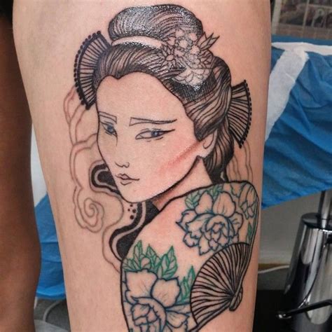 A Woman S Leg With A Tattoo On It And Flowers In Her Hair Is Shown