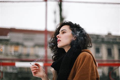 Beautiful Woman Smoking Cigarette Outdoor By Stocksy Contributor Marija Kovac Stocksy