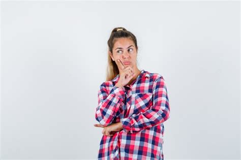 Free Photo Young Lady In Checked Shirt Propping Chin On Hand And