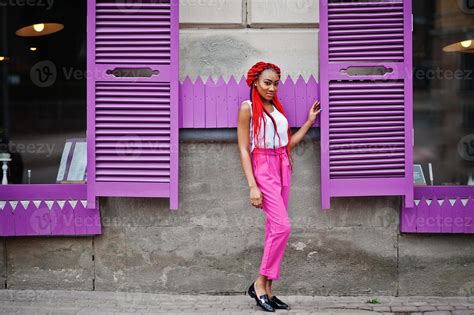 fashionable african american girl at pink pants and red dreads posed outdoor 10489308 stock