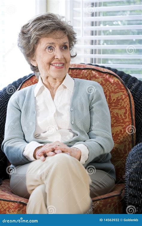 Senior Woman Sitting On Living Room Chair Stock Photo Image Of Couch