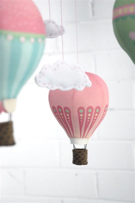 Three Hot Air Balloons Are Hanging From Strings