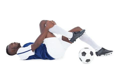 Premium Photo Football Player Lying Down Injured