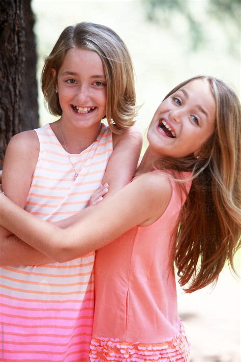 Twin Sisters Hugging And Laughing By Stocksy Contributor Dina Marie Giangregorio Stocksy