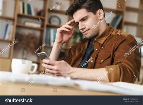 Image Handsome Brooding Young Man Using Stock Photo 1747165592