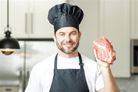 Premium Photo Man Chef Cooker Hold Meat Beef Male Chef In Chefs Uniform With Raw Meat Beef