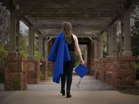 A High School Graduate Walks Away With Cap And Gown In 2020