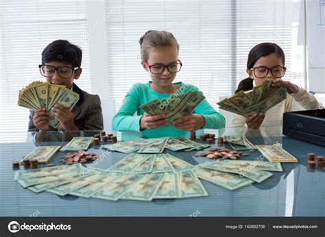 Maybe you would like to learn more about one of these? Business kids counting money — Stock Photo © Wavebreakmedia #162892758