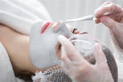 Face Peeling Mask Spa Beauty Treatment Woman Getting Facial Care By Beautician At Spa Salon