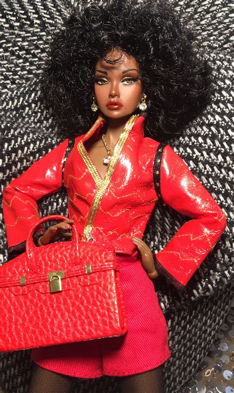A Barbie Doll Is Holding A Red Purse