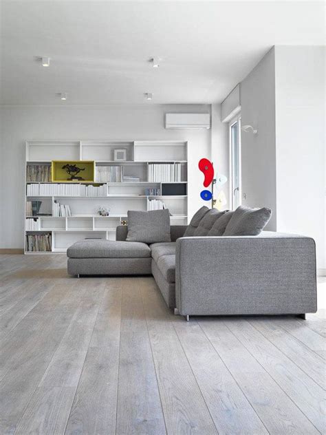 A light grey sofa with a bright yellow chair in the same style. Well lit modern open plan living area with white walls and contrasting grey sofa and t… | Grey ...