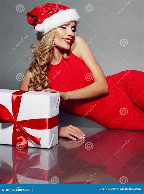 Blonde Santa In A Red Dress Holding Christmas T Stock Image Image Of Body Christmas 61317709