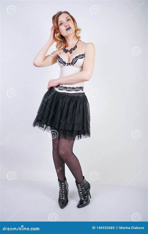 Charming Caucasian Blonde In Lace Beige Lingerie Bodice And Black Skirt