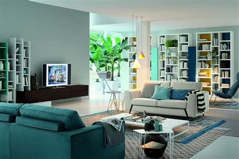 Academic books span a bookshelf's shelves while decorations rest on a wall stand. Modern Modular Wall Units For Living Room