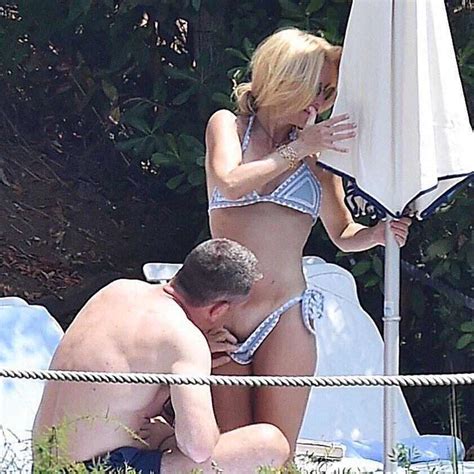 Gillian Anderson Ignoring A Guy Pulling Down Her Bikini And Looking At