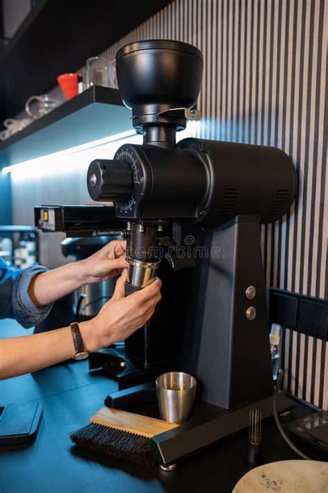 Barista Hands Using Modern Coffee Grinding Machine In A Cafe Stock