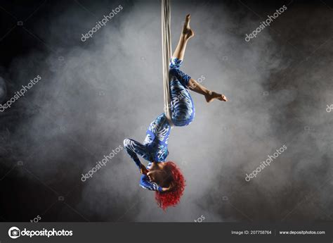 Athletic Sexy Aerial Circus Artist With Redhead In Blue Costume Making Tricks On The Aerial Silk