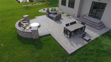 Laying a brick paver patio in your backyard (via: Backyard Fire Pit with Seat Wall and Paver Patio - Oasis ...