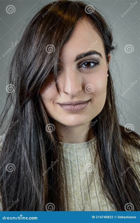 Portrait Of A Beautiful Young Woman With Long Dark Hair Who Smiles