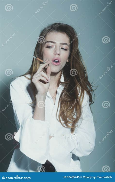 Pretty Woman Or Girl With Long Hair Smoking Cigarette Stock Image