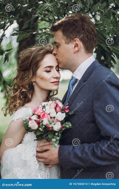 Sensual Groom Kissing Beautiful Bride On The Forehead Newlywed Couple