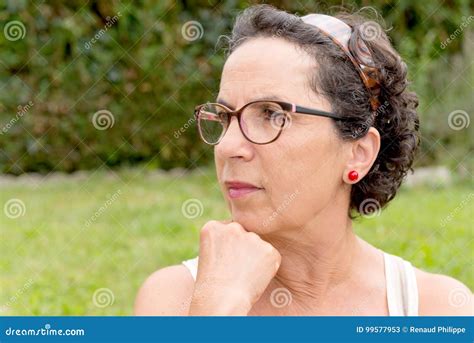 Portrait Of A Middle Aged Brunette Woman With Eyeglasses Outdoor Stock