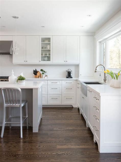 The countertops would be white quartz and matte black hardware. Beautiful white and gray kitchen features coffee stained ...